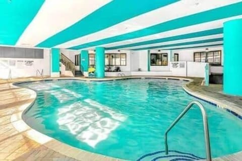Spacious indoor pool with bright coastal design—open year-round for all-weather fun.