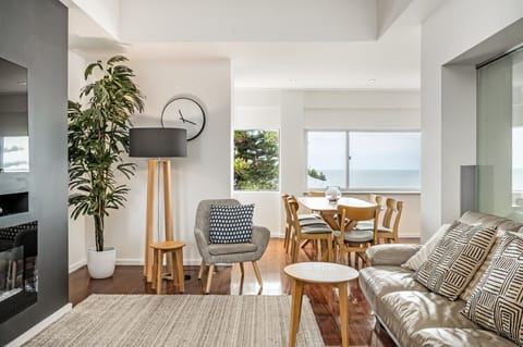 The living room boasts a warm, inviting atmosphere, thanks to its beautifully crafted wooden setup. The wooden accents and furniture pieces blend seamlessly with the plush sofa, creating a cozy and rustic ambiance that`s perfect for relaxation and sociali