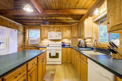 Experience the charm of cabin life in our rustic kitchen, where warm wood tones and natural light create a cozy atmosphere