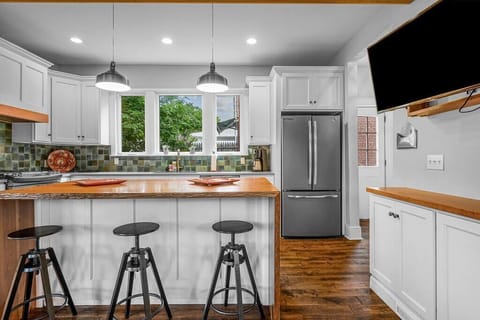 This fully equipped kitchen offers many custom touches, from the waterfall edge cherry peninsula, to the cle-tile back splash. The huge windows bathe the entire room with natural light!