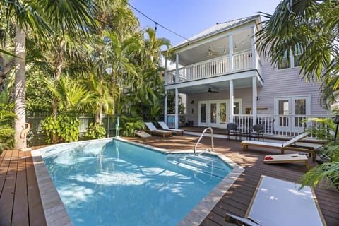 Private heated pool with plenty of seating and outdoor games