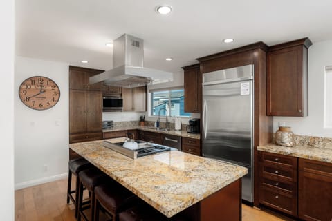 Kitchen with gas stove/range, dishwasher, dual Keurig & drip coffee pot and kitchen essentials.