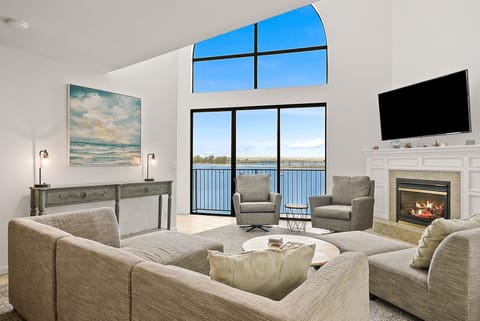 Living room w/ fire place, smart TV and bay views