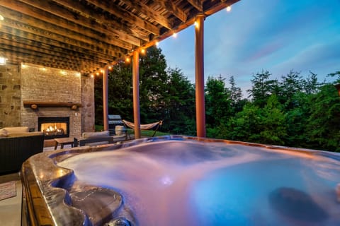 Unwind in your private hot tub under twinkling lights, cozy up by the outdoor fireplace, or relax in the hammock surrounded by lush greenery