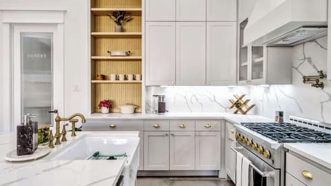 Start your day brewing coffee in this stunning kitchen, where every detail invites warmth and togetherness. Cook with ease, gather at the island, and share meals that turn into lasting memories in this elegant yet inviting space.