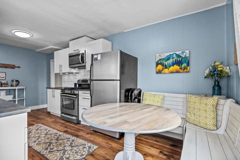 Dining area with bench seating and additional chairs. 