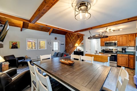 Dining area featuring a raised table and chairs, providing a stylish and comfortable space for meals and gatherings