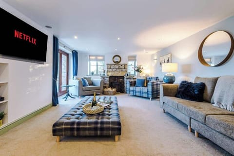 The spacious living room benefits from a 55-inch SMART TV with Netflix on the wall, plenty of space to sit down with family and friends in the evening, and a gorgeous log burner to keep warm in the evenings.