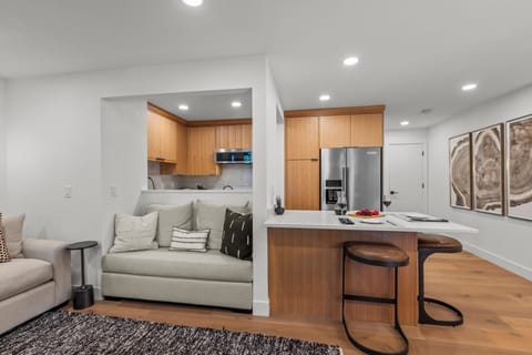 The open concept dining and living area with a breakfast bar with seating for 2.