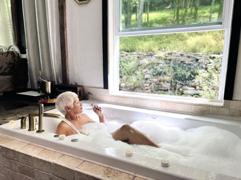 Large 2 person Jacuzzi bath tub located directly in your bedroom. 