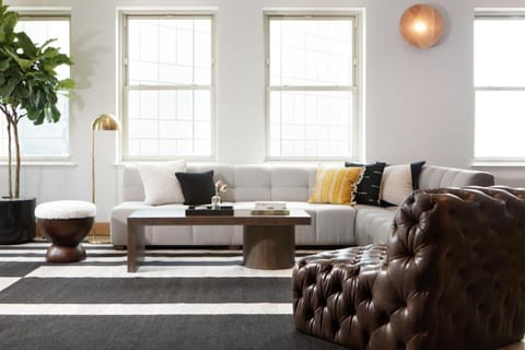 Unwind in a sunlit lounge with plush seating and calm vibes.