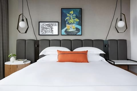 Sink into cloud-soft pillows under warm, modern pendant lights.