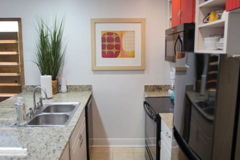 Fully functioning kitchen with a stove/oven, fridge, microwave and dishwasher.