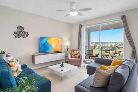 Stylish Living Room with 65" Smart TV and awesome LAKE view!#Disney #Parks #kingdom #springs #StoreyLake #Apartment #Vacation #Rental #waterpark #Kissimmee #Orlando #universal #citywalk
