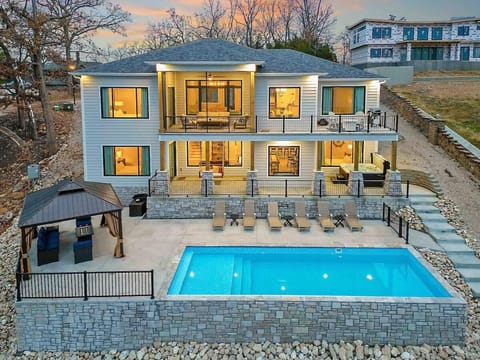 Gorgeous Lake Home sleeps 24, has private pool and it's own Pickleball Court! Luxury abounds with Game room, Man cave, fire pits, indoor electric fireplace and gourmet kitchen. Enjoy our year round Hot Tub, relax poolside or park your boat lakeside.