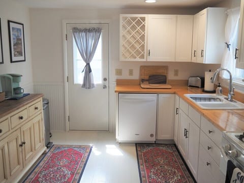 KITCHEN:  Another view of the kitchen, showing the side door entrance and the "coffee cabinet".