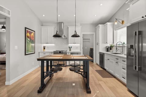 Teak industrial dining table with stools that pull out! Very unique and inviting!