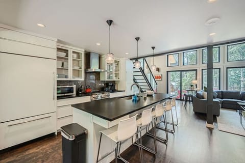 This chef`s kitchen features Sub-Zero appliances and a Wolf gas grill, seamlessly flowing into the dining and living areas. Large sliding doors lead to back patio, while stunning Vail Mountain views from the front patio enhance indoor-outdoor living.