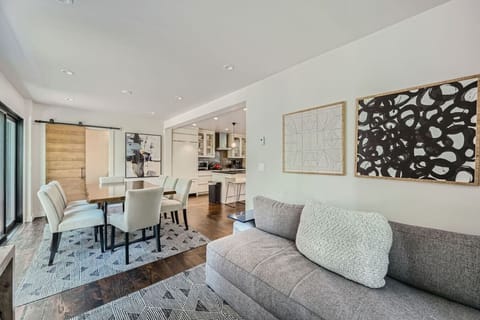 The dining room opens to a private backyard patio featuring a cozy gas fireplace, perfect for gatherings. Adjacent, a second living room adds extra comfort, seamlessly connecting to the kitchen for easy entertaining and family time.