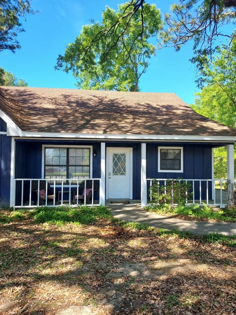 Front of home. Front porch sitting area. Private entry from driveway on right.