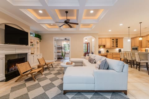 Spacious common area with a fireplace, TV, and large sectional.