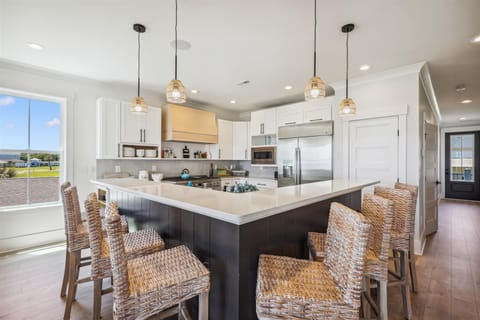 The kitchen island provides additional counter space for serving snacks or meals