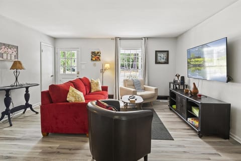 comfortable living room with a huge TV on the wall