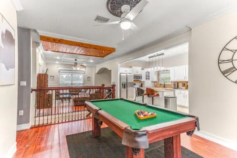 A pool table to play and enjoy with easy access to the living room and kitchen