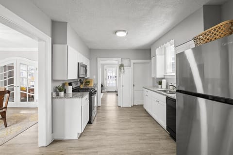 Spacious kitchen with ample counter space and a full-size refrigerator.  Great for cooking and storing your food! 🧊