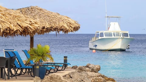 Unwind in shaded loungers as boats drift by quietly.