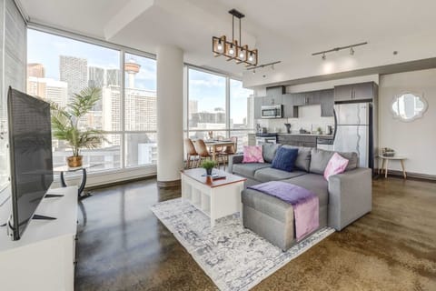 Modern open-concept living room with smart TV and city views