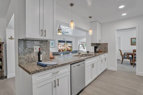 In the Kitchen looking out through the Florida room to the pool and canal.