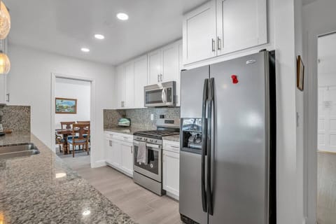 Modern appliances with a 5 burner gourmet gas stove.