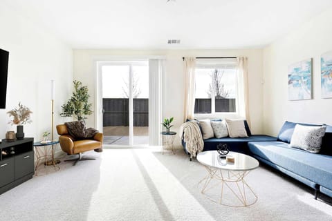 Spacious, sun-filled living room designed for relaxing and entertaining in style. 
