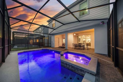 Nighttime pool view glows w/ ambient lighting for a resort-style feel.