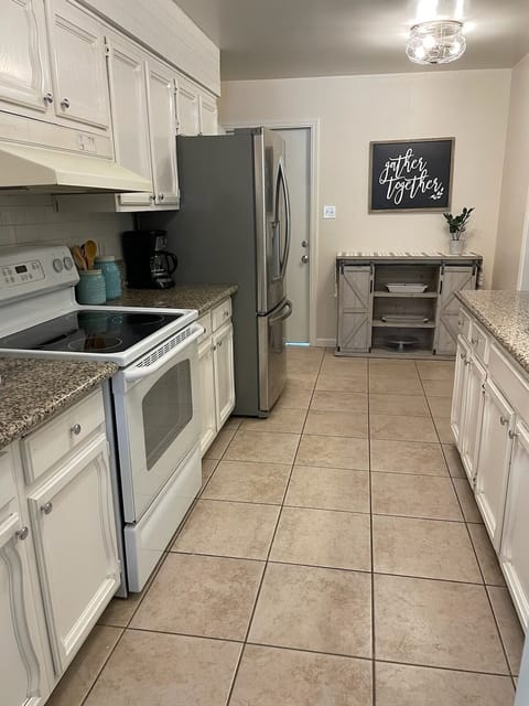 Galley kitchen fully equipped with cookware and utensils 