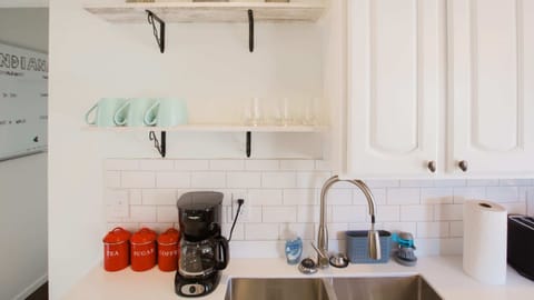 Newly renovated kitchen dual sink and coffee maker. Large subway tile kitchen backsplash
