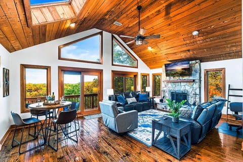 Spacious cabin living room with beautiful views & a cozy wood-burning fireplace