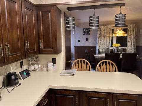 Breakfast bar and dining room table viewed from kitchen