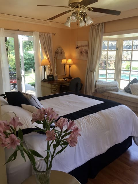 STUDIO BEDROOM FRENCH DOORS LEADING TO STONE PATIO AND 8' WINDOW SEAT & POOLVIEW