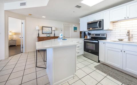 Prepare meals in the bright kitchen featuring stainless appliances and a spacious counters for casual dining