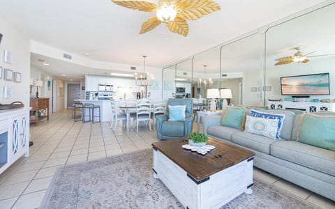 Relax in the airy living space featuring a sofa with queen sleeper, large TV, and a stylish dining area for shared meals