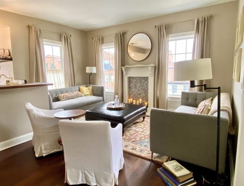 Apt1_LR_Living_Faux Fireplace_Leather Ottoman_West Elm couches_