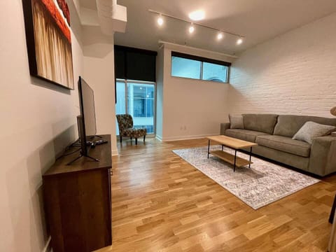 Living room adjacent to kitchen with sleeper sofa.