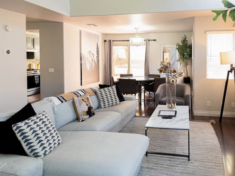 Spacious and cozy living room comes with a L-shaped couch, 58" 4K HDTV and books