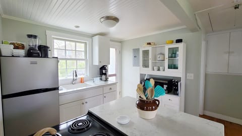 Nicely equipped kitchen with door to back patio
