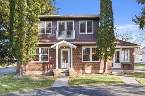 Horseshoe driveway leads to front entrance of Home with Juliette balcony above