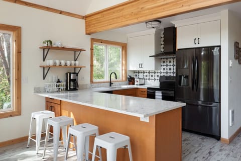 Kitchen with induction range and counter seating for 4.