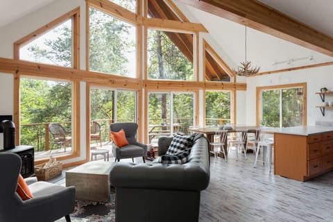 Main floor open concept living room + dining room with views of the deck.
