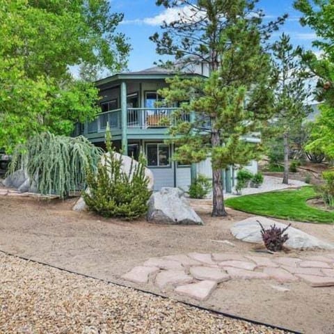 Welcoming cabin entry surrounded by towering pine trees, offering fresh mountain air and a peaceful forest setting—the perfect first impression for your Big Bear Lake getaway.